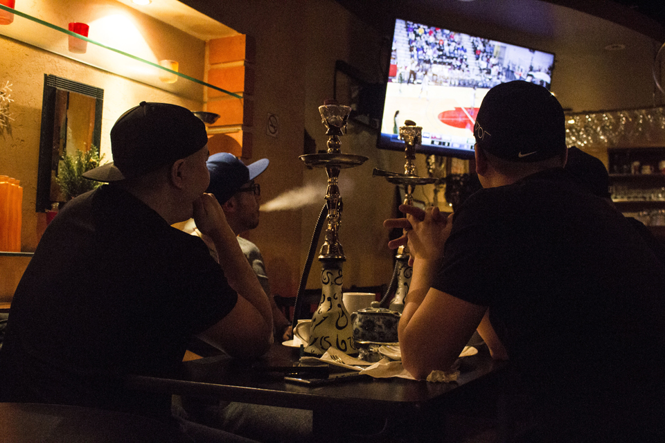 A group of friends catch up with the game in the background. // Photo © Angelyn Francis & Urbanology Magazine 